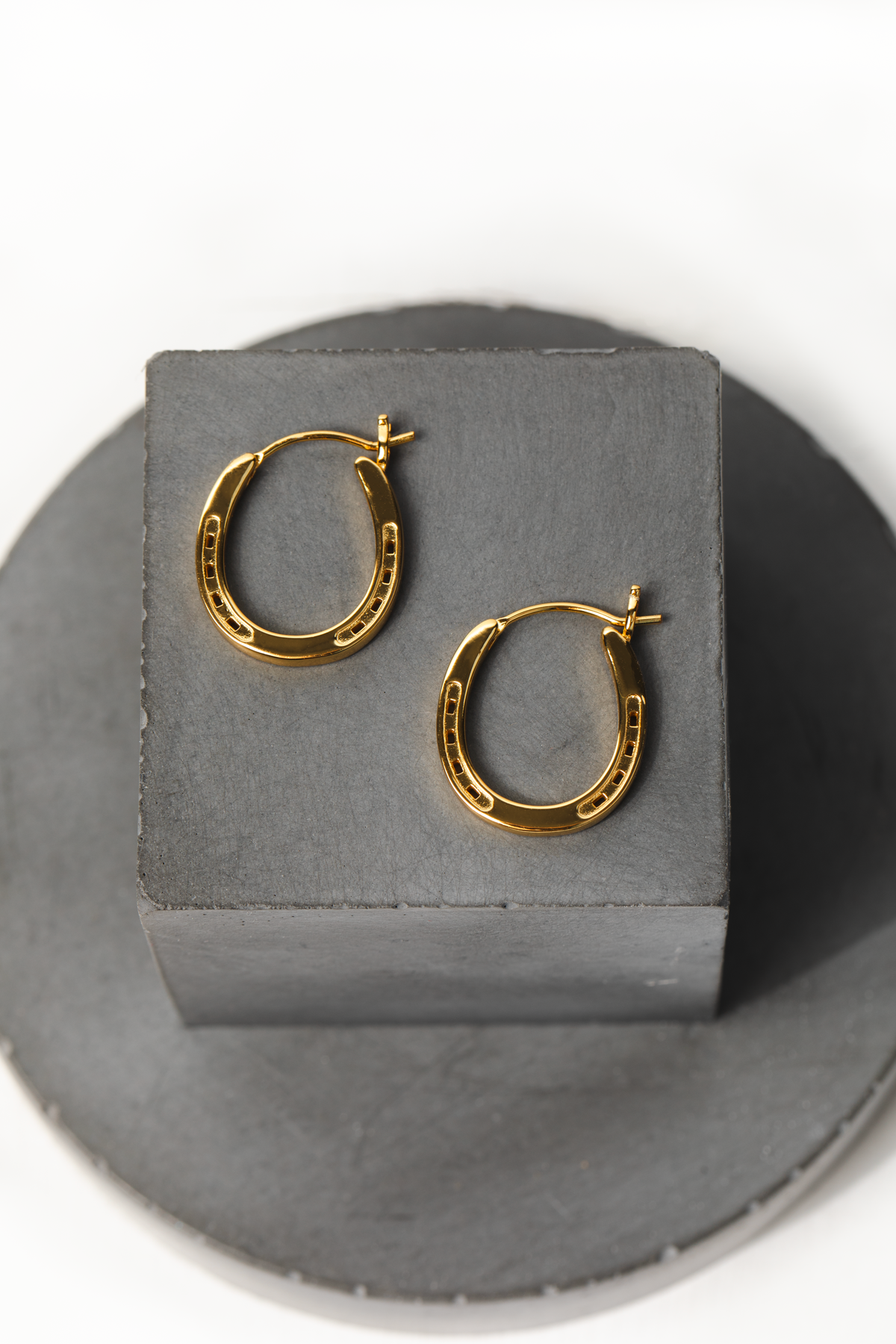 A pair of elegant gold hoop horseshoe earrings, showcasing their shine and design.
Our Gold Horse Shoe Earrings are an unique equestrian gifts crafted from high-quality gold. This gold horse shoe earrings are the perfect equestrian themed gift and a good luck charm. Our Horseshoe earring  are the perfect birthday present.