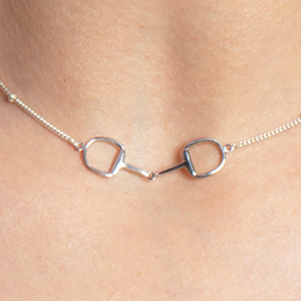 A silver Snaffle Bit Necklace is perfect for horse enthusiasts, it adds a refined touch to any outfit and makes a memorable equestrian gifts for women and horse themed gifts, embodying sophistication in its design.  Ideal  for horse lovers, fans of equestrian inspired jewelry, horseback riders,  silver horse jewelry. 