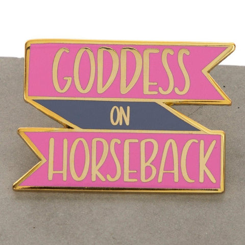 A goddess on horseback enamel pin in pink and touch of  purple, inscribed with Goddess on Horsesback, perfect for horse lovers , collectors, horse girls, horse riders, show jumping, horseback riders and more. This pin design  is a cool equestrian gifts. A piece that encourages and empowers our women in the equestrian life. Our pin design is a cool equestrian gifts, for young horse riders  and  Pink lovers.