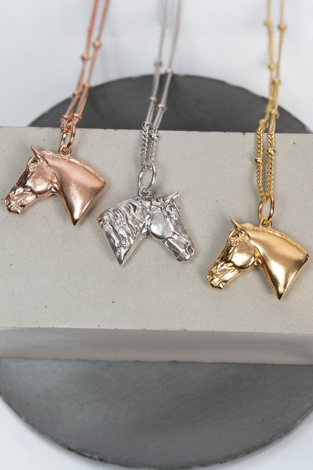 Three horse head necklaces with detailed features such as its mane. The necklace Ideal as a unique gift, this pendant celebrates the beauty and strength of horses. Best gifts for horseback riders and one of a kind horse gift ideas for her. A unique horses gift and equestrian enthusiasts.