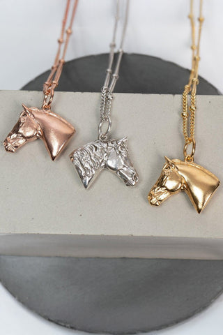 Three horse head necklaces with detailed features such as its mane. The necklace Ideal as a unique gift, this pendant celebrates the beauty and strength of horses. Best gifts for horseback riders and one of a kind horse gift ideas for her. A unique horses gift and equestrian enthusiasts.