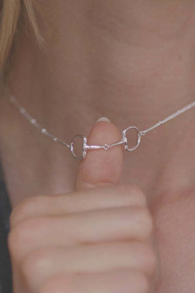 A silver Snaffle Bit Necklace is perfect for horse enthusiasts, it adds a refined touch to any outfit and makes a memorable equestrian gifts for women and horse themed gifts, embodying sophistication in its design.  Ideal  for horse lovers, fans of equestrian inspired jewelry, horseback riders,  silver horse jewelry. 