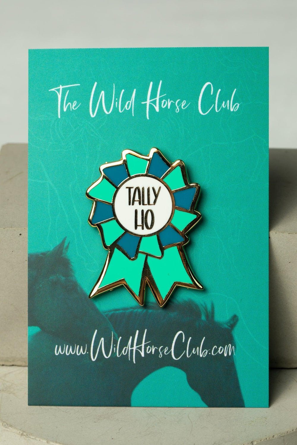 Enamel pin featuring Tally Ho Green on a green card with two horses and with label The Wild Horse Club. Text on pin reads : TALLY HO. Perfect for horse girls, horse riders, show jumping, horseback riders and more. This pin design  is a cool equestrian gifts.