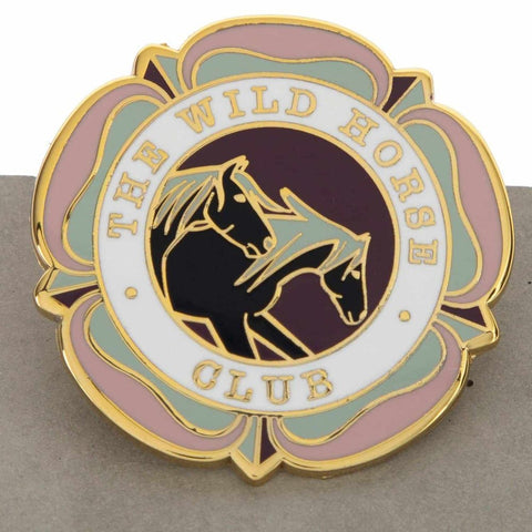 A colorful flower with a clover and two horses  design, this enamel pin representing the wild horse club, highlighting the beauty and spirit of wild horses. Text on pin reads: The Wild Horse Club. Perfect for horse girls, horse riders, show jumping, horseback riders and more. This pin design  is a cool equestrian gifts. 